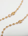 A close-up image of a For Art's Sake® Coral Glasses Chain featuring a gold-plated chain with an intricate design. The chain boasts oval-shaped links with solid connector pieces and circular interlocking segments, creating an elegant and luxurious look on a white background.