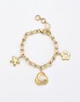 The Daisy Bracelet by For Art's Sake® is a 24-karat gold-plated piece featuring three unique charms: a starfish, a flower, and a rose with a pearl center. The chain is composed of oval links and includes an adjustable clasp with a small round loop for secure fastening. It is elegantly displayed on a plain white background.