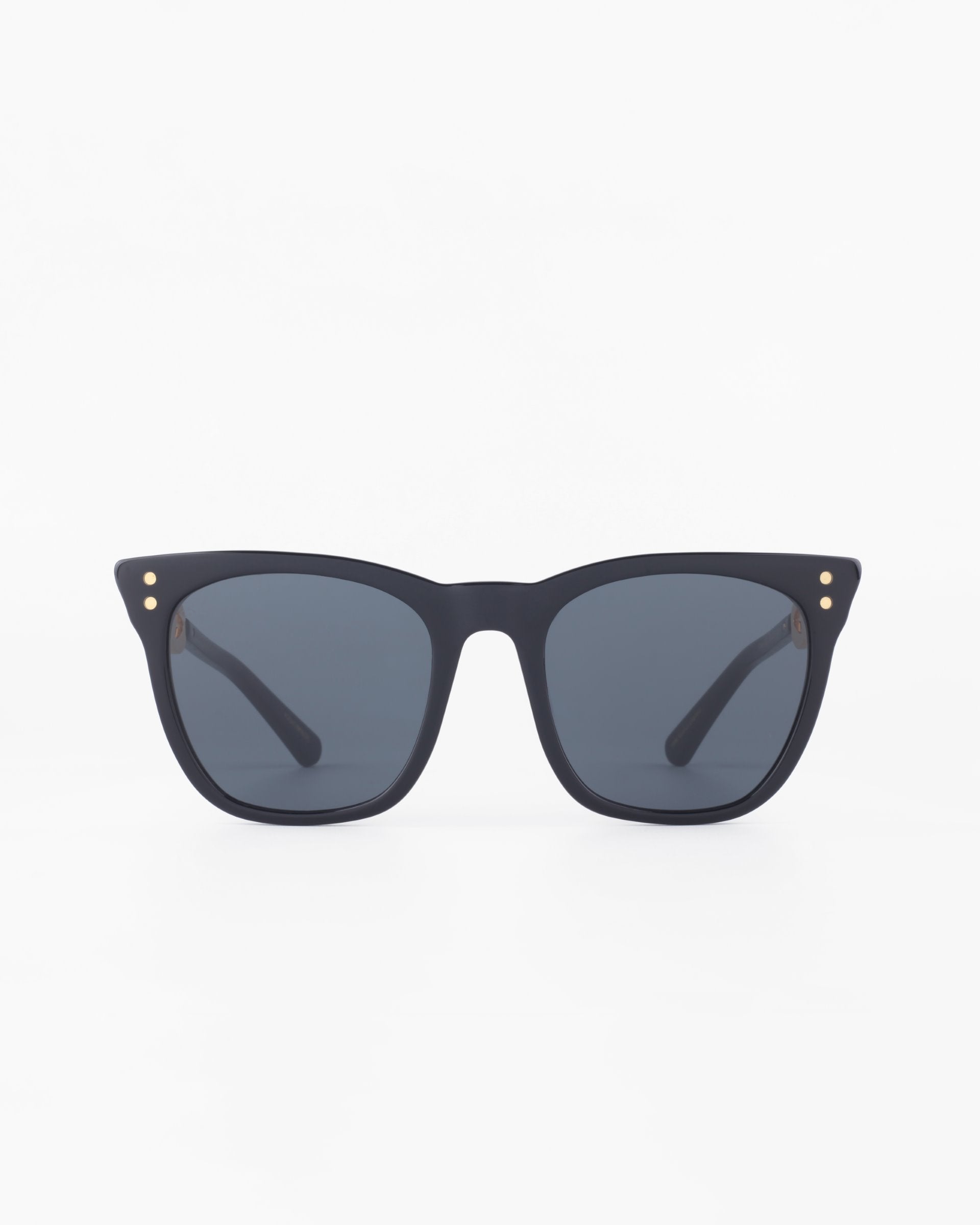 A pair of black square-frame acetate sunglasses with dark lenses. The Deco sunglasses by For Art&#39;s Sake® have three small dot accents on each corner of the frame. The background is plain white.