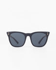 A pair of black square-frame acetate sunglasses with dark lenses. The Deco sunglasses by For Art's Sake® have three small dot accents on each corner of the frame. The background is plain white.