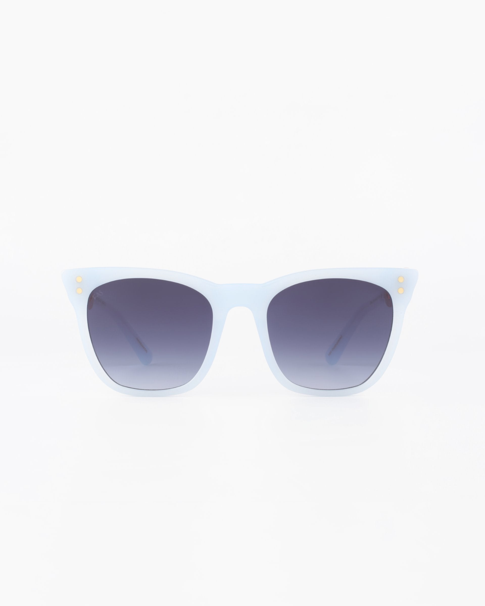 A pair of stylish cat-eye sunglasses named Deco from For Art&#39;s Sake® with a light blue acetate frame and dark, ombre lenses sits against a plain white background. The frame has subtle gold accents near the temples.
