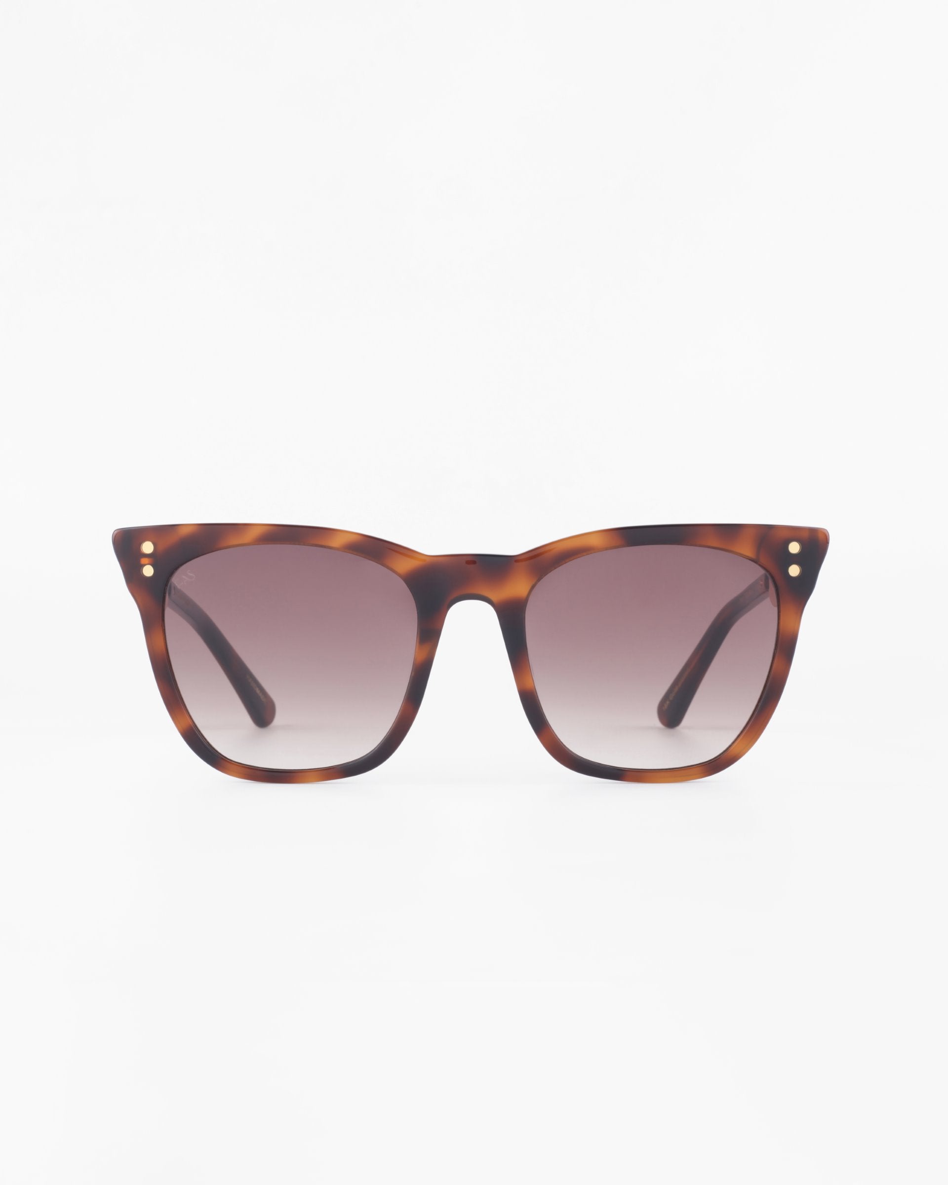 Front view of a pair of tortoiseshell Deco sunglasses by For Art&#39;s Sake® with a classic square frame design. Crafted from premium acetate, the sunglasses feature gradient lenses and small metallic dots near the hinges on both sides of the frame. The background is plain white.