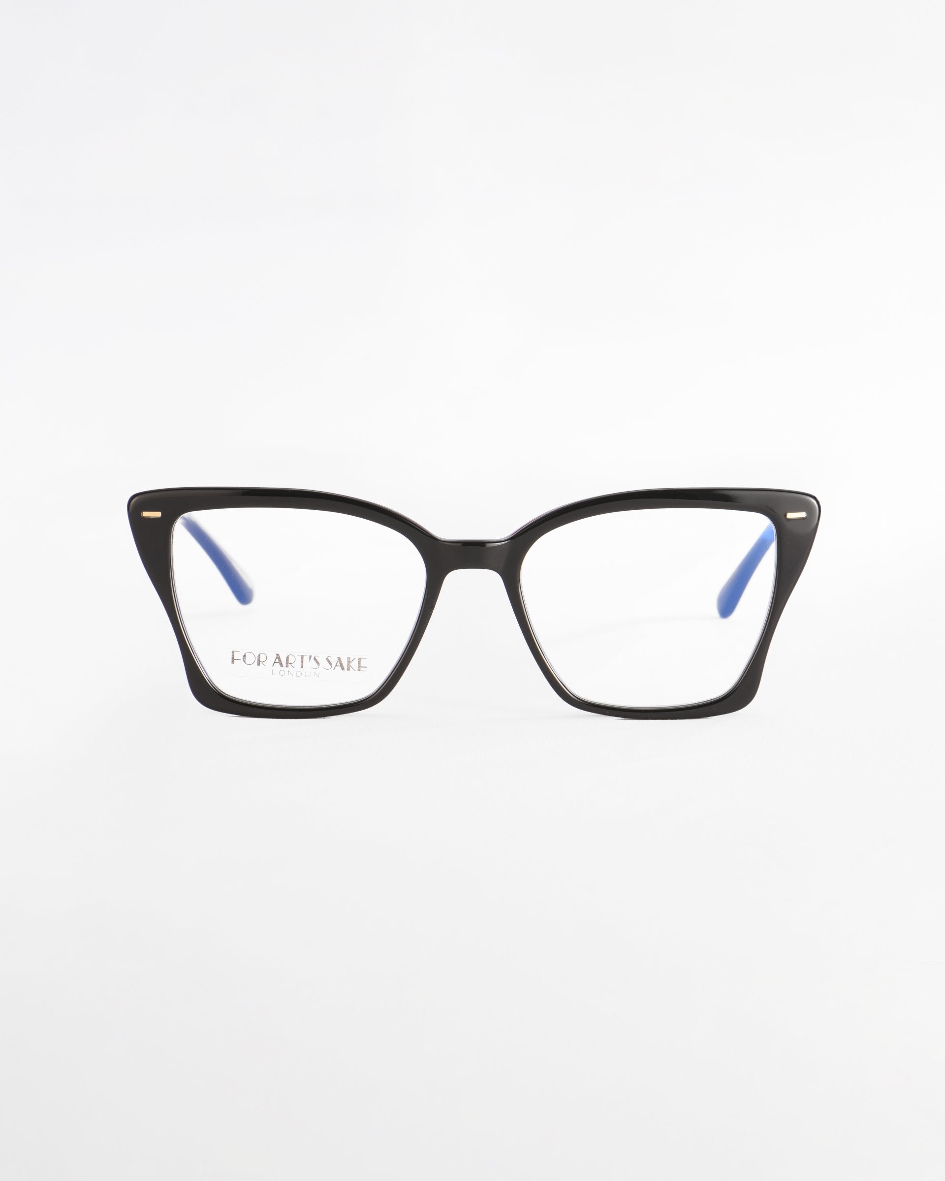 A pair of stylish black cat-eye Dion eyeglasses with thin blue temples and tortoiseshell frames. The lenses are clear and offer UV protection, featuring an engraving &quot;FOR ART&#39;S SAKE®&quot; on the left lens. The glasses are positioned against a plain white background.