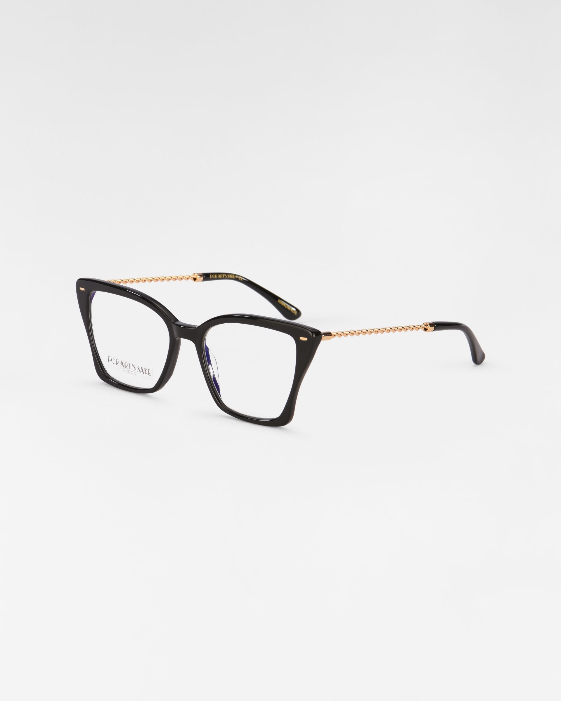 A pair of rectangular Dion eyeglasses with tortoiseshell frames and gold-accented temples featuring intricate chain-like detailing, equipped with a blue light filter, showcased on a plain white background by For Art&#39;s Sake®.