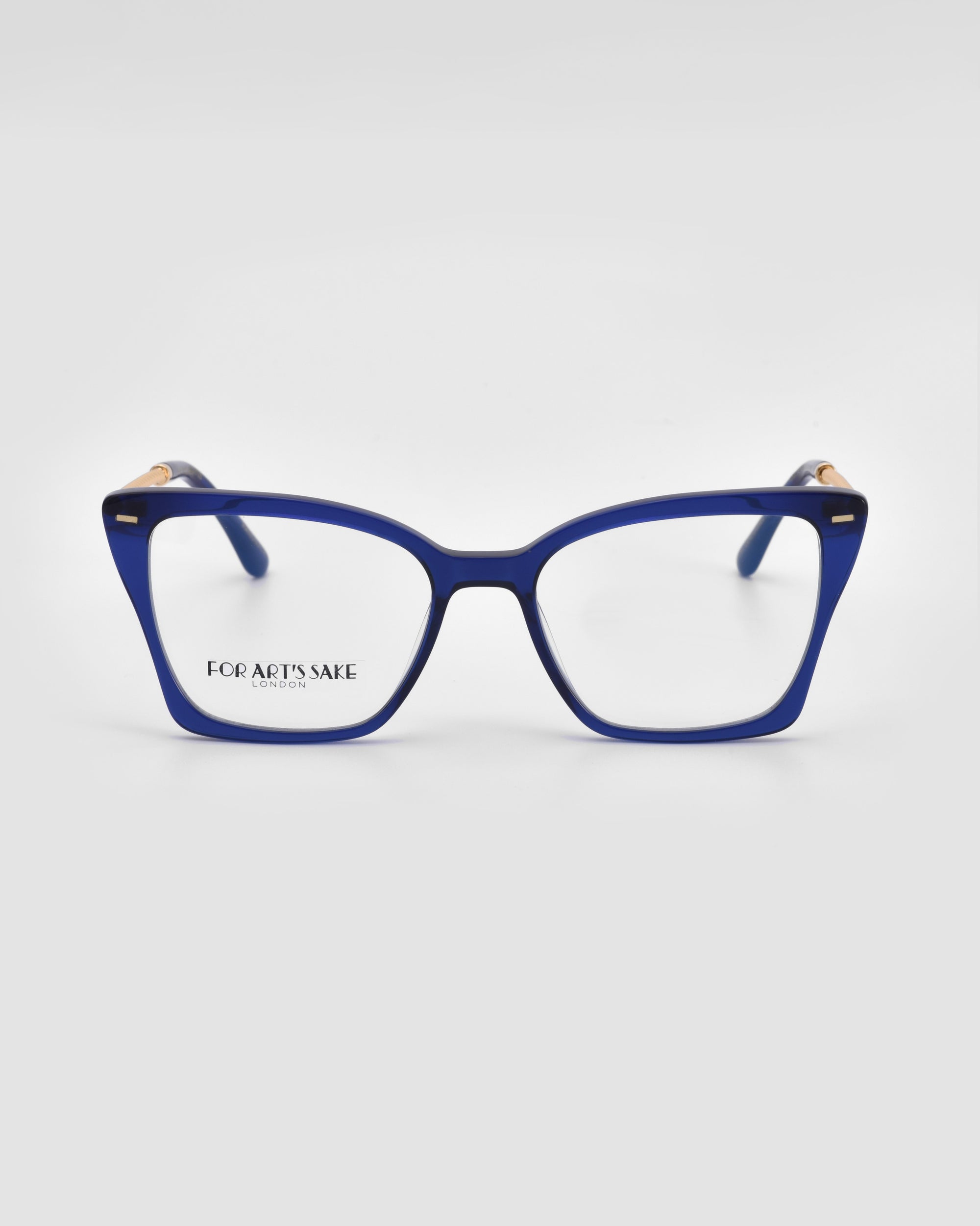 The Dion eyeglass frames by For Art&#39;s Sake® are blue, square-shaped frames with a subtle cat-eye design. They feature gold accents on the temples, provide UV protection, and are showcased against a light grey background.