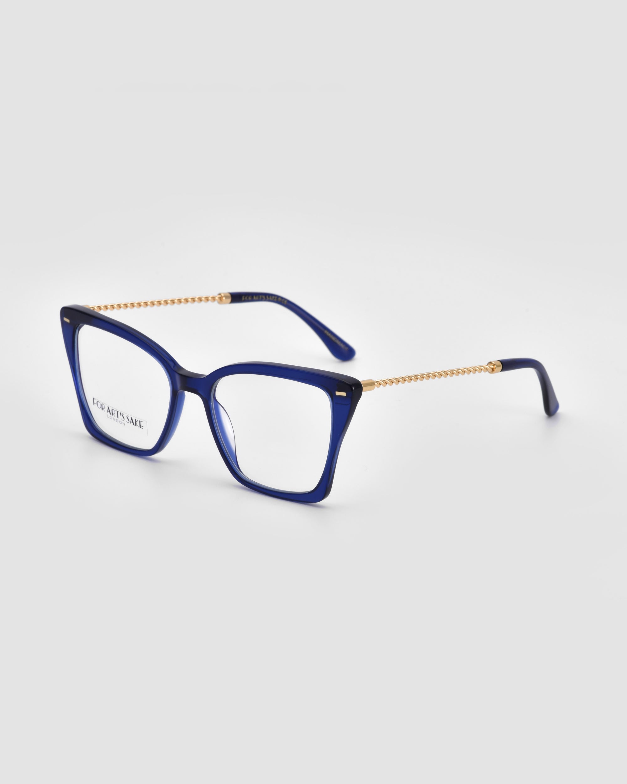 A pair of stylish navy blue Dion eyeglasses with square frames and gold chain temples. Featuring 18-karat gold-plated details, the glasses are set against a plain, light grey background. The brand name &quot;For Art&#39;s Sake®&quot; is visible on the inner left lens.