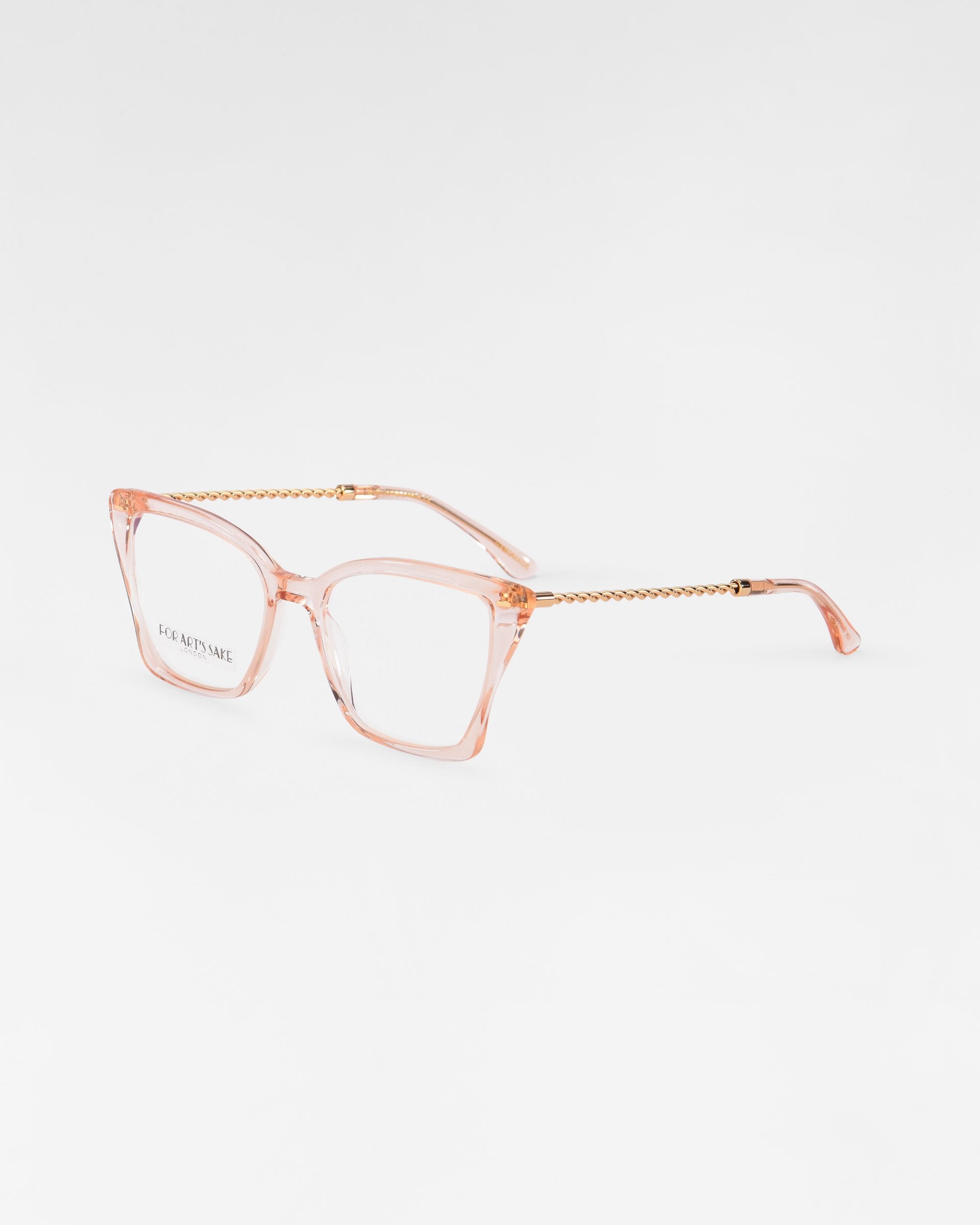 A pair of Dion eyeglasses from For Art&#39;s Sake® with pink-tinted, transparent rectangular frames and thin, twisted metallic gold temples. The left lens has the text &quot;KOMAROV&quot; printed in gold. These chic glasses also feature UV protection lenses. The background is white.