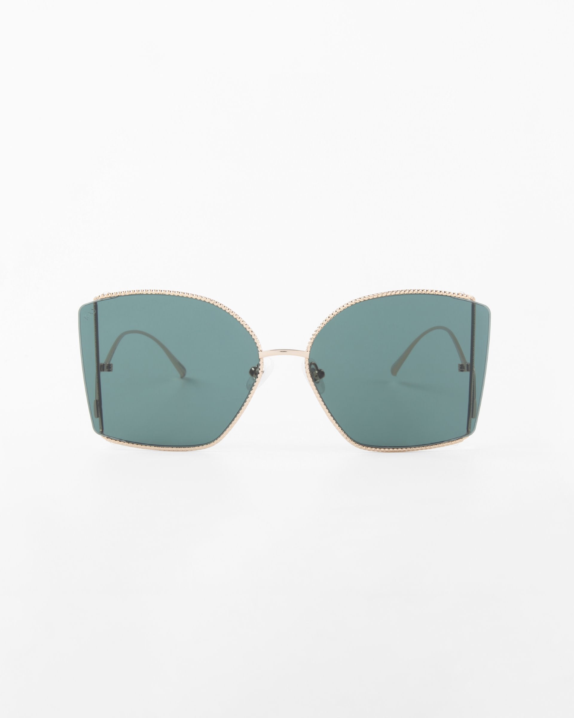 A pair of sunglasses, Dixie by For Art&#39;s Sake®, with oversized square frames and dark green, shatter-resistant nylon lenses. The glasses feature handmade gold-plated frames and gold arms that curve slightly at the ends. The UV protection ensures safety, set against a plain white background.