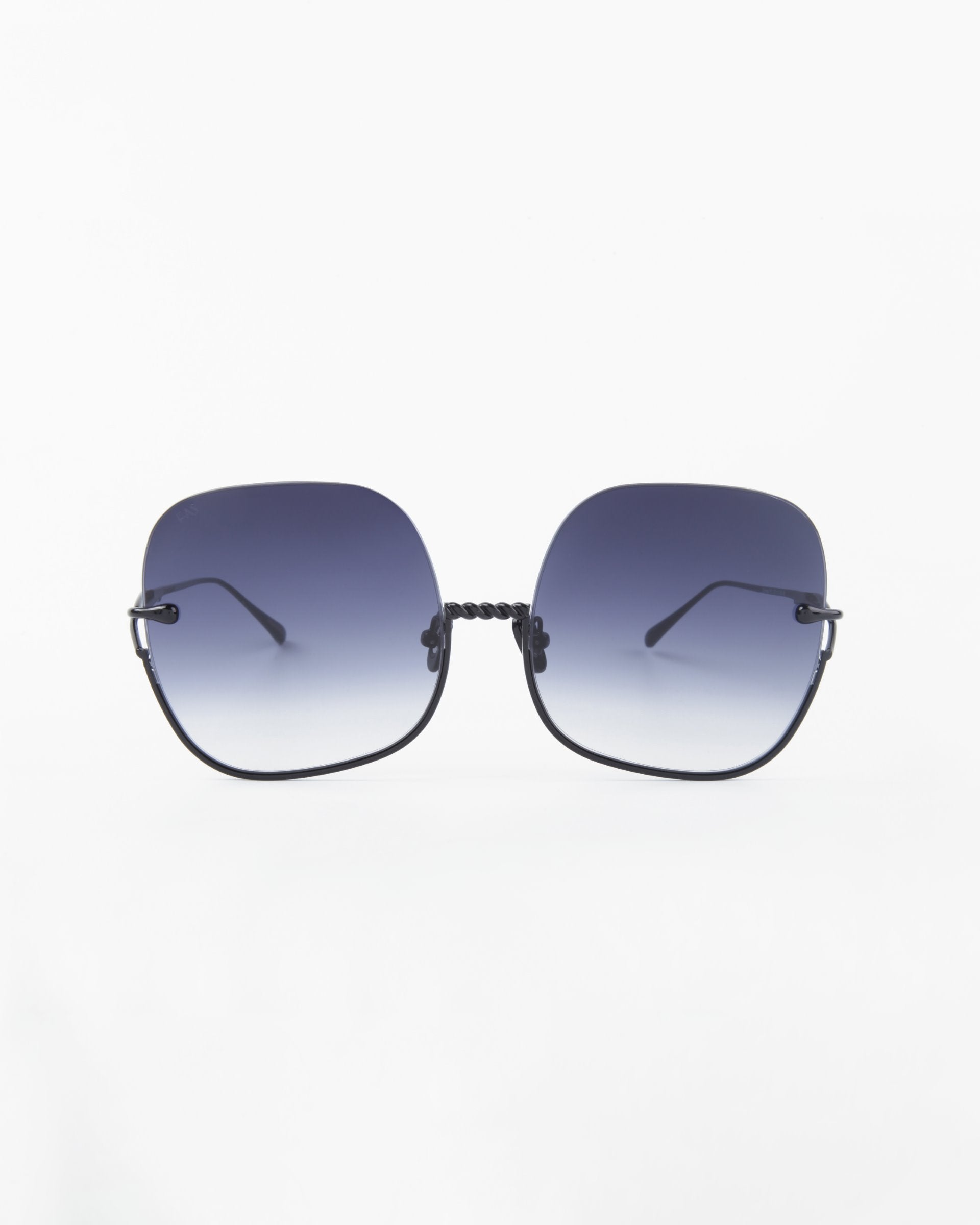 A pair of Duchess by For Art's Sake®: oversized, square-shaped sunglasses featuring thin black frames and gradient blue lenses that fade from dark at the top to lighter at the bottom. The shatter-resistant lenses offer UVA & UVB protection, ensuring both style and safety. The background is plain white.