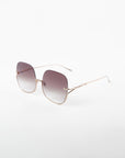 A pair of square-shaped Duchess sunglasses by For Art's Sake® boasting a handmade gold-plated frame and shatter-resistant, gradient lenses. The lenses transition from dark at the top to lighter shades toward the bottom, offering full UVA & UVB protection. The Duchess sunglasses by For Art's Sake® are positioned on a plain white background.