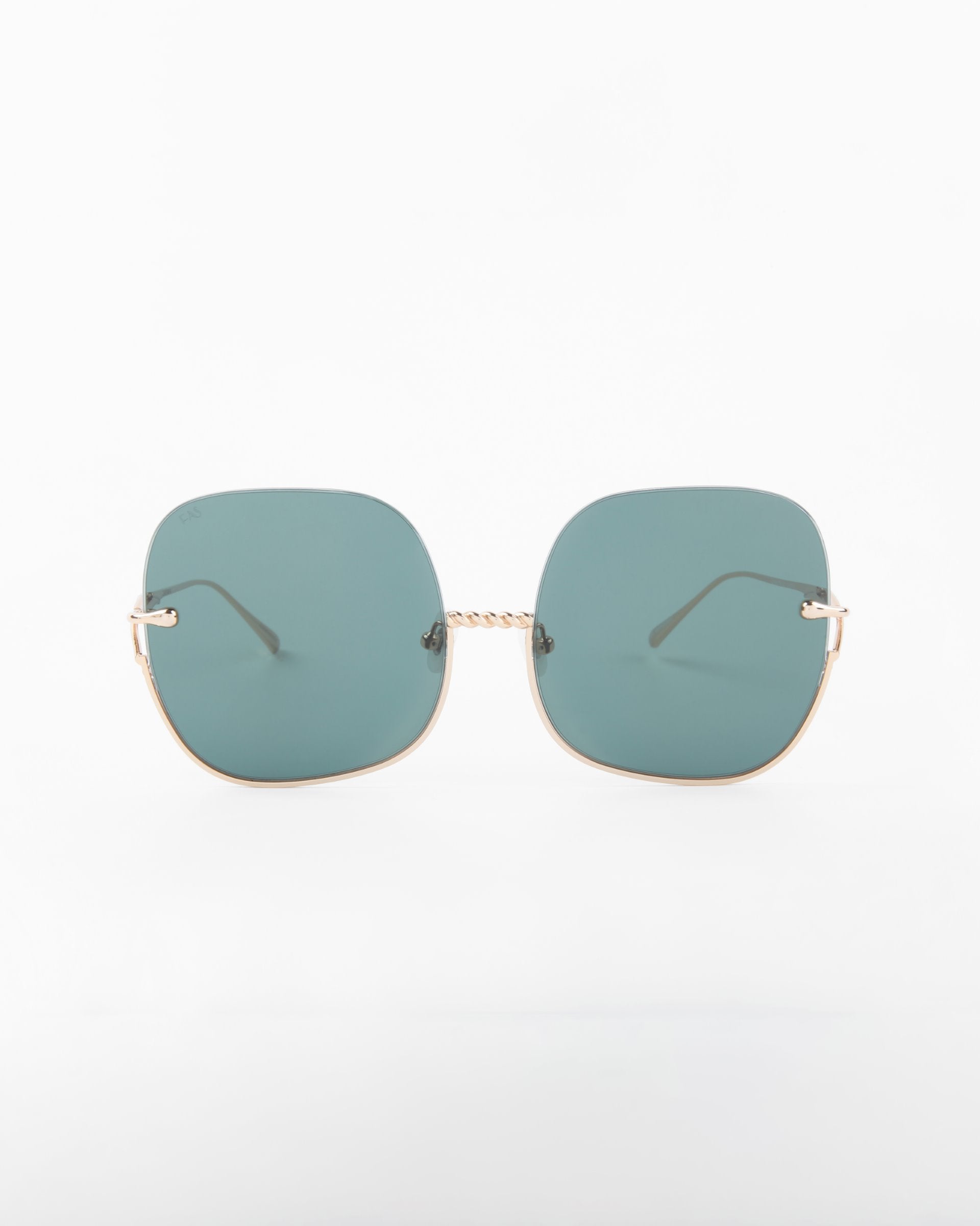 A pair of stylish Duchess sunglasses from For Art's Sake® with large, square-shaped, shatter-resistant lenses tinted in a cool blue color. The frame is minimalistic with thin, gold-colored arms and a delicate twisted bridge. With UVA & UVB protection, the handmade gold-plated frame stands out against the plain white background, emphasizing the design.