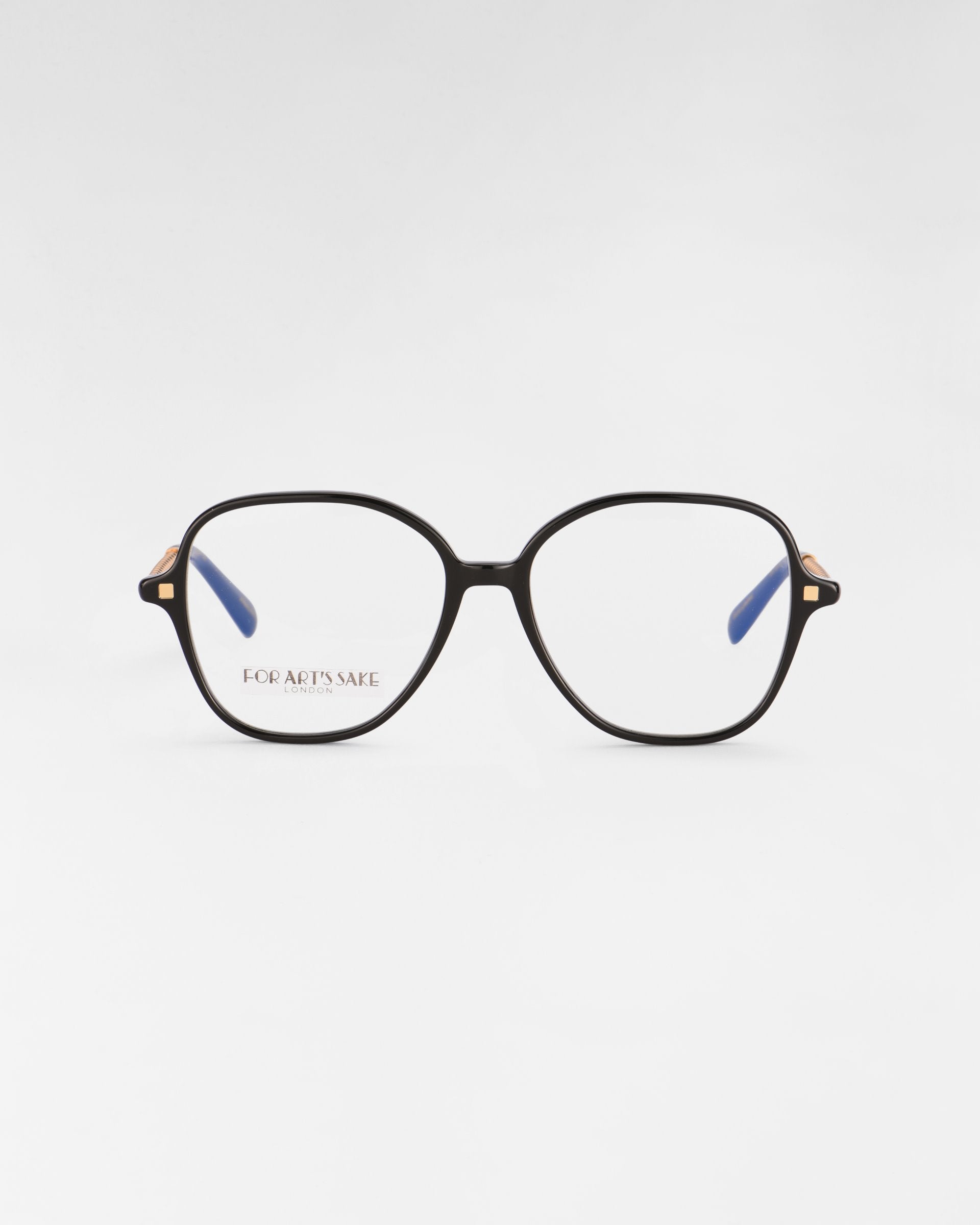 A pair of black-rimmed Dumpling eyeglasses with a slight geometric shape. The glasses have clear lenses featuring a blue light filter, and the inside arms are blue. The words &quot;For Art&#39;s Sake®&quot; are visible on the left lens. The glasses are set against a plain white background.