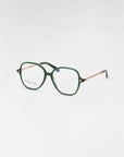 A pair of For Art's Sake® Dumpling eyeglasses with green rectangular frames and transparent lenses featuring a blue light filter. The temples are adorned with a textured gold pattern and have black tips. The product is displayed on a plain white background.