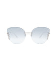 A pair of stylish oversized cat-eye sunglasses with large, lightly tinted blue lenses and a silver metal frame. The temples feature a delicate and intricate cut-out design. The overall look is modern and elegant, complemented by adjustable nosepads for a comfortable fit. Introducing Girlboss by For Art's Sake®.