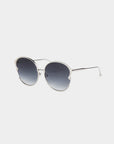 Introducing the Alectrona sunglasses by For Art's Sake®: a pair of stylish handmade eyewear featuring silver metal frames and large, round, gradient lenses. The thin and sleek temples extend from the edges of the UVA & UVB-protected lenses, which darken at the top and gradually fade to a lighter shade at the bottom.