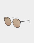 A pair of stylish For Art's Sake® Alectrona sunglasses with round brown-tinted, shatter-resistant lenses and a thin black metal frame. The design features a minimalist bridge and temple arms, with adjustable jade nose pads for comfort. The background is plain white.