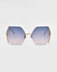 A pair of Generation sunglasses from For Art's Sake® with gradient lenses transitioning from blue at the top to light pink at the bottom. The gold-plated stainless steel frame features thin arms extending from the lenses and jadestone nosepads. The glasses are set against a plain white background.