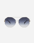 A pair of stylish Mania sunglasses by For Art's Sake® featuring octagonal, nylon lenses with a gradient tint from dark blue at the top to light at the bottom. The stainless steel frames are thin and metallic, with black temple arms and adjustable nose pads for comfort. The background is plain white.