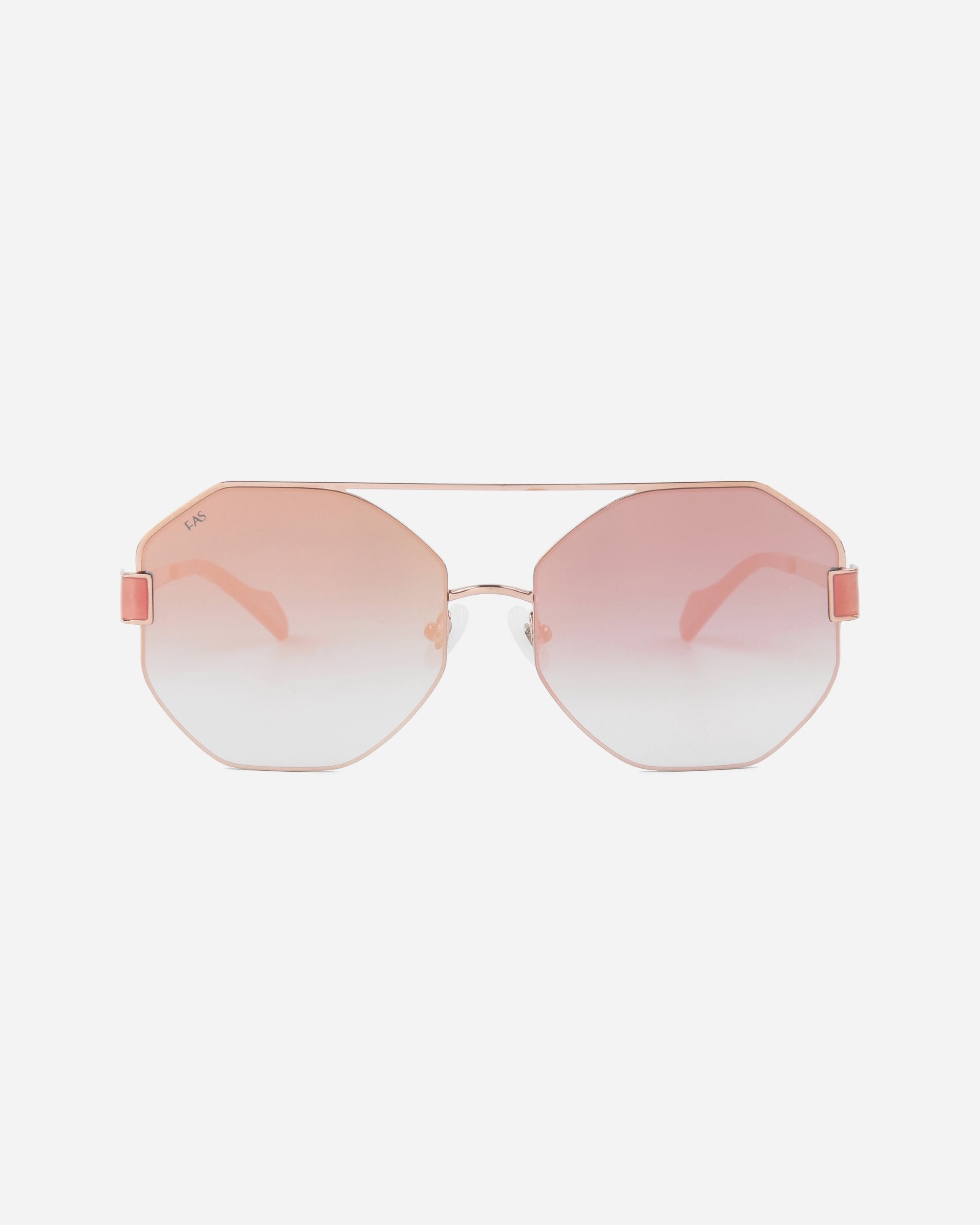 A pair of For Art&#39;s Sake® Mania sunglasses with rose-tinted gradient nylon lenses and thin 18-karat gold-plated frames. The lenses are hexagonal in shape, and there are pink accents on the sides of the frames near the hinges. The background is plain white.