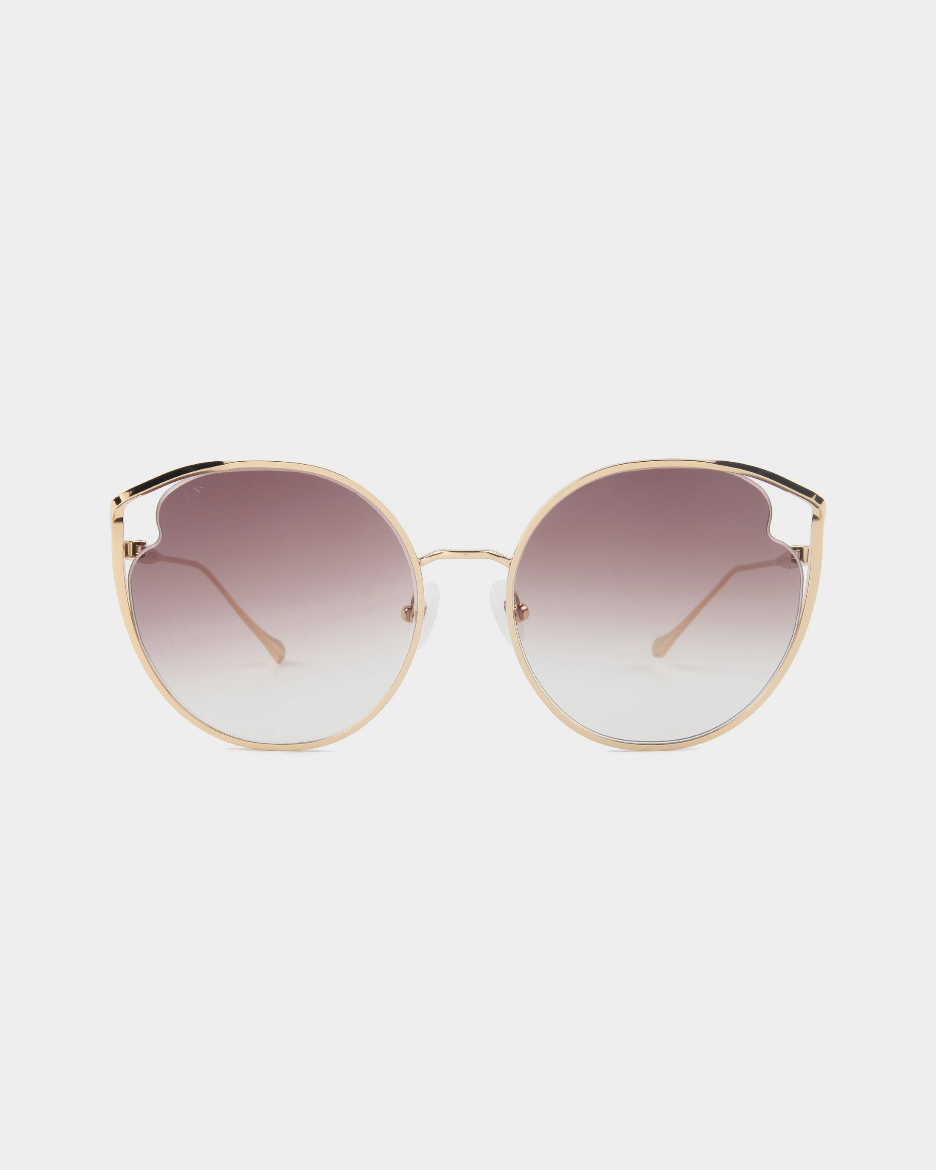 A pair of round &quot;Cat&quot; sunglasses by For Art&#39;s Sake®, featuring a gold metal frame and gradient Nylon lenses that transition from dark at the top to light at the bottom, complete with adjustable nose pads and UVA &amp; UVB protection, set against a plain white background.