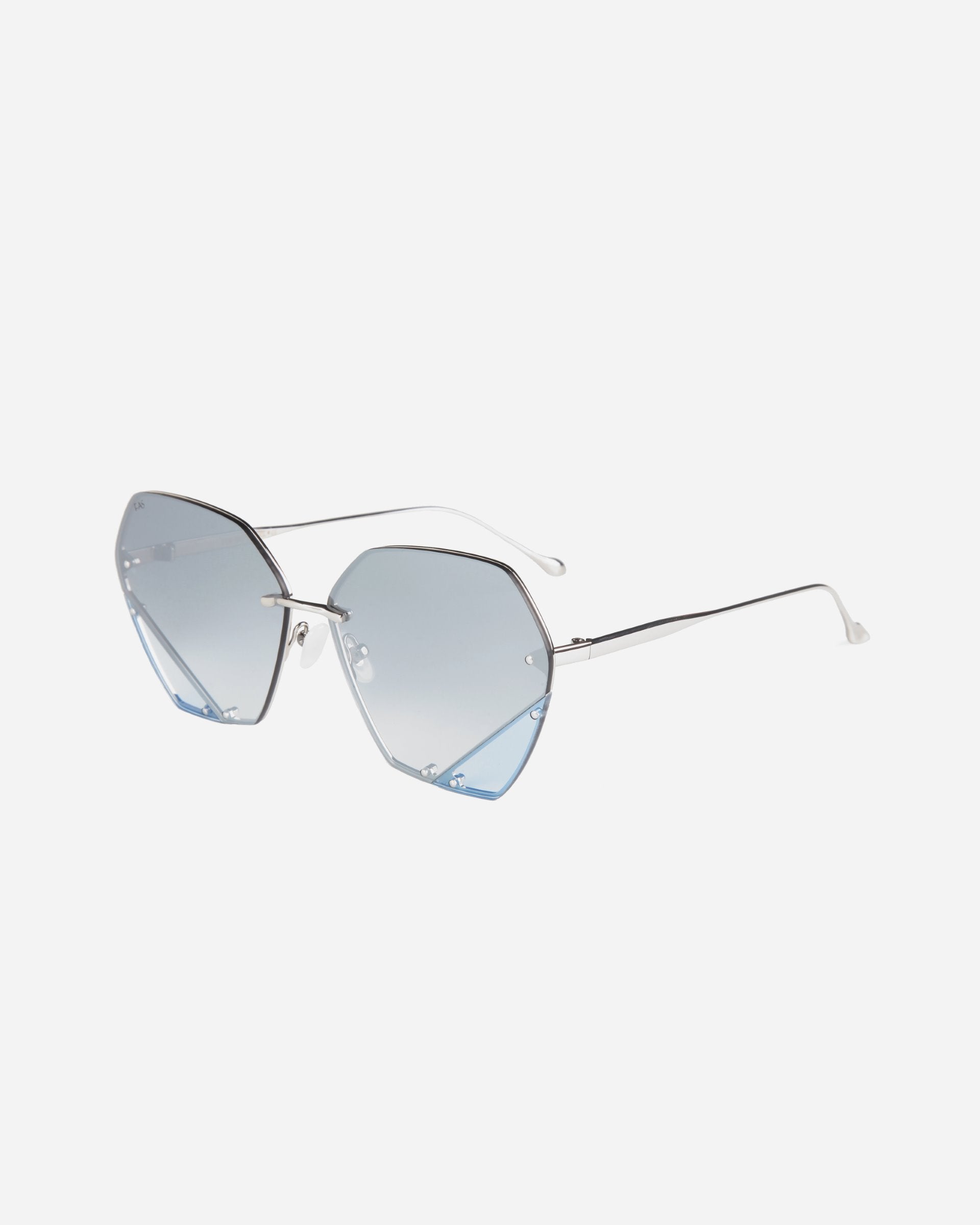 A pair of stylish sunglasses with hexagonal, gradient blue lenses and thin silver metal frames. Featuring jadestone nosepads for added comfort, the design is modern and minimalistic, providing a chic look - the Icy by For Art&#39;s Sake®.