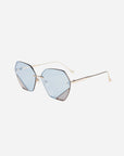 A stylish pair of For Art's Sake® Icy sunglasses featuring geometric, light blue-tinted lenses and thin, gold metal frames with jadestone nosepads, set against a plain white background.