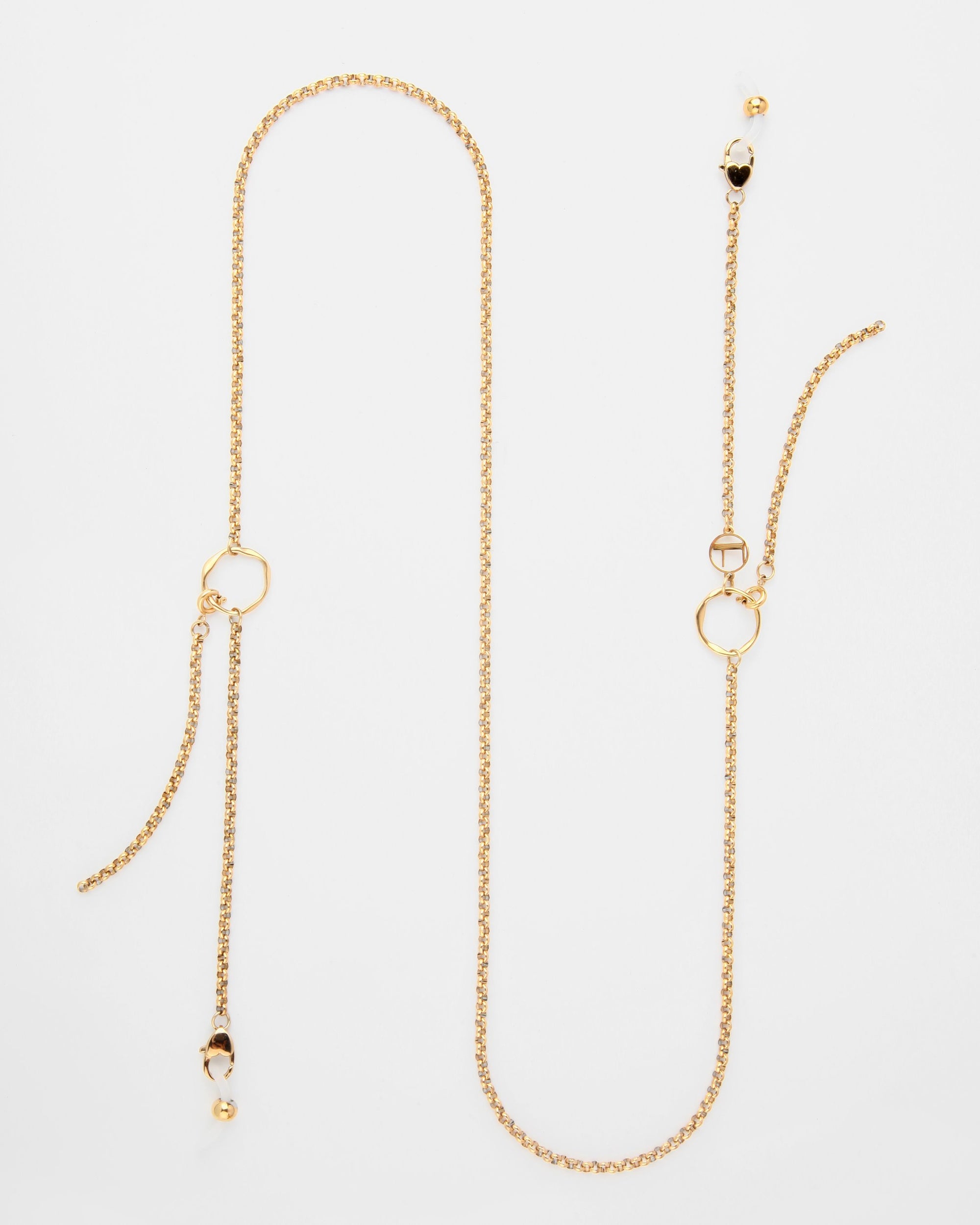 A long 18K gold-plated chain necklace with two geometric-shaped pendants and beaded accents. The adjustable loops and clasp provide a perfect fit. The minimalist, sophisticated design is laid out against a plain white background, similar to the Florentina Glasses Chain by For Art's Sake®.