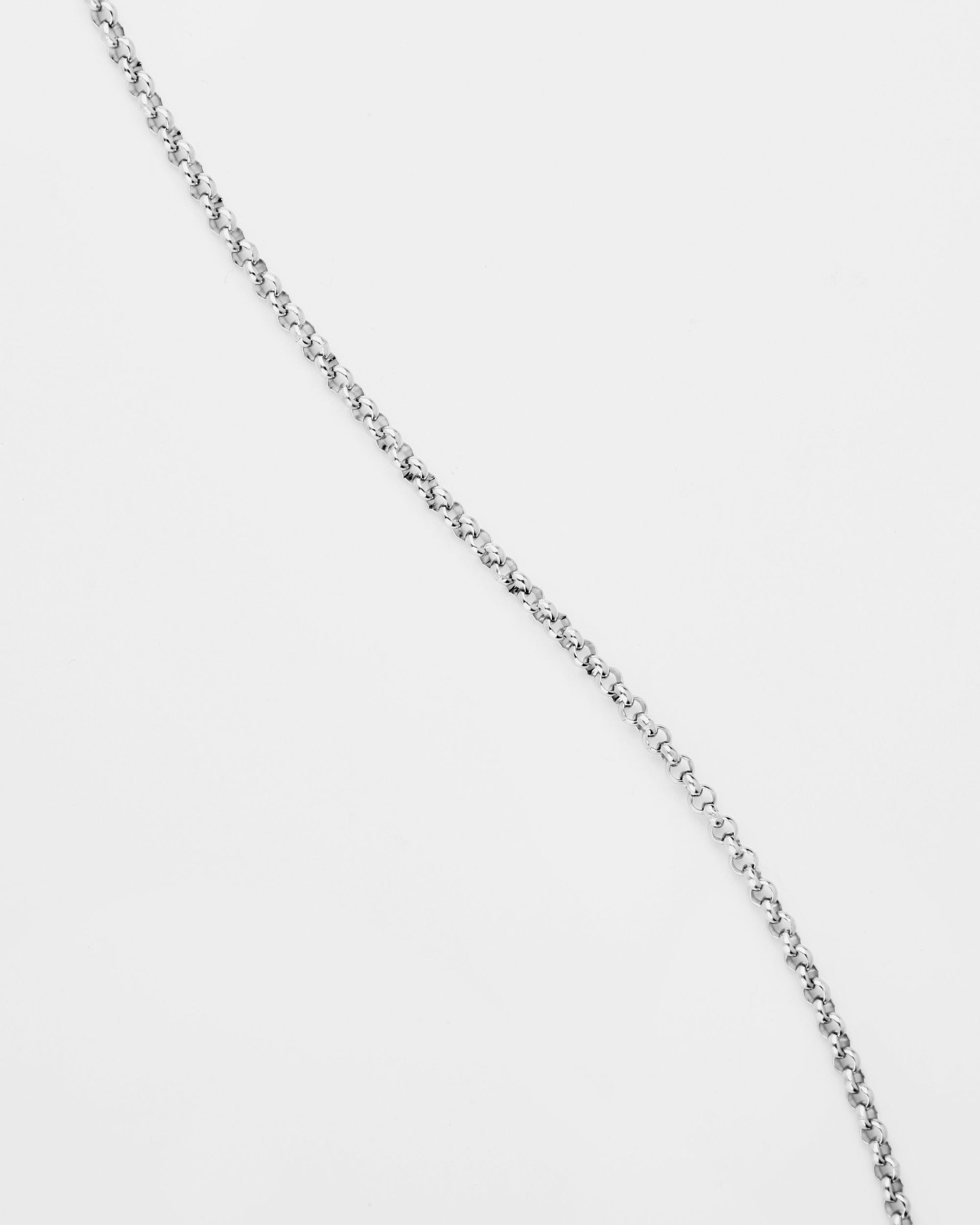 A close-up image of a For Art&#39;s Sake® Florentina Glasses Chain against a plain white background. The chain appears lightweight with small, round links, arranged diagonally across the image.