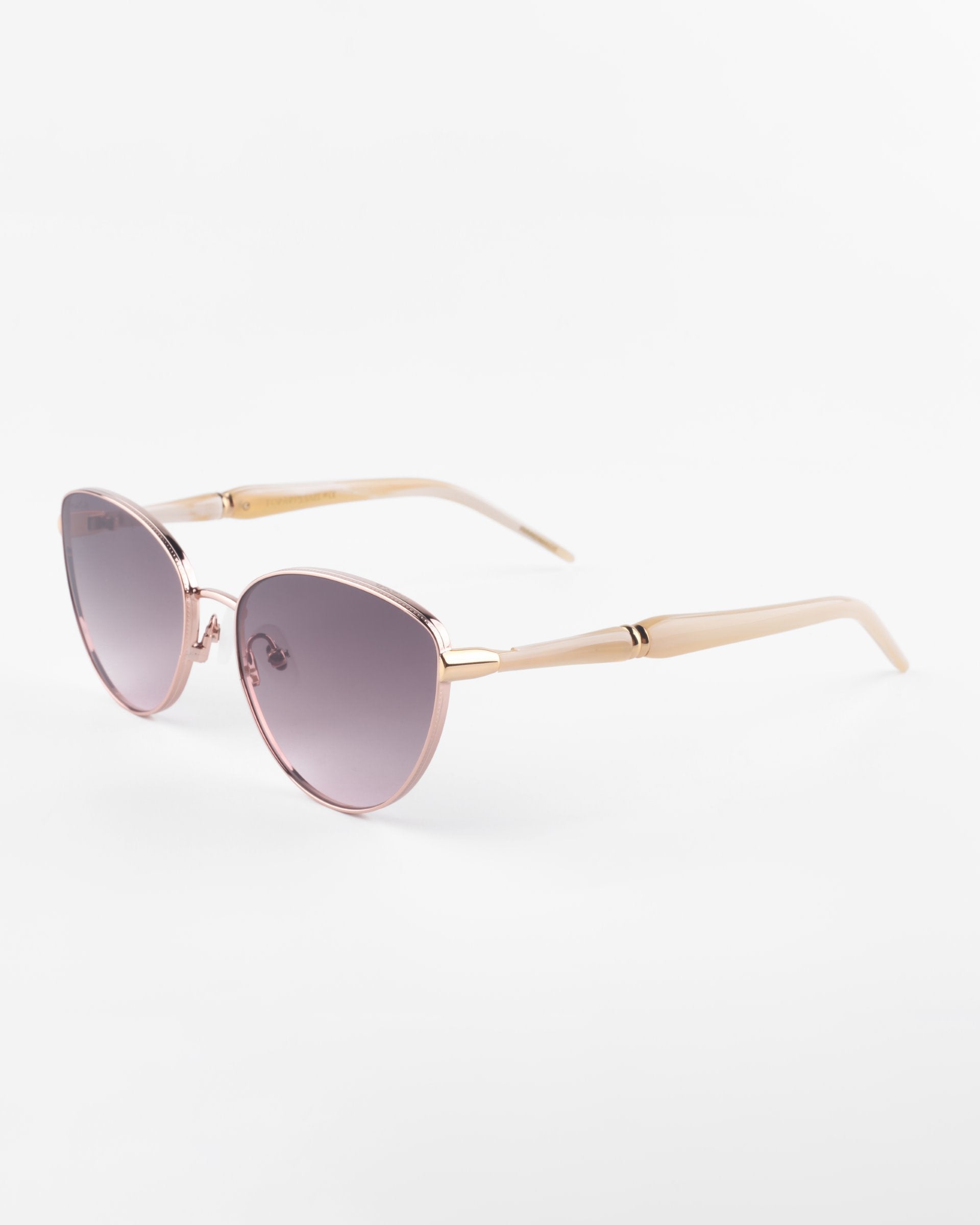 A pair of stylish Frida Brush sunglasses by For Art&#39;s Sake® with pink-tinted, ultra-lightweight lenses and a light pink frame. The arms of the glasses are also light pink and slightly angled outward, ensuring comfort. With UVA &amp; UVB protection, these Frida Brush sunglasses by For Art&#39;s Sake® are photographed against a plain white background.