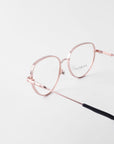 A pair of rose gold wireframe eyeglasses with a rounded shape and thin temples featuring black tips. The 18-karat gold-plated frames are equipped with prescription lenses, enhancing the minimalist and elegant design against a white background. For Art’s Sake®'s Frida Floral eyeglasses effortlessly combine style and function for a timeless look.