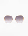 A pair of Frida Mask sunglasses by For Art's Sake® with large, square lenses that have a gradient tint from dark gray to clear. Made with gold-plated stainless steel and ultra-lightweight nylon lenses, they offer 100% UVA & UVB protection. The sunglasses have thin arms and a minimalist design, set against a white background.