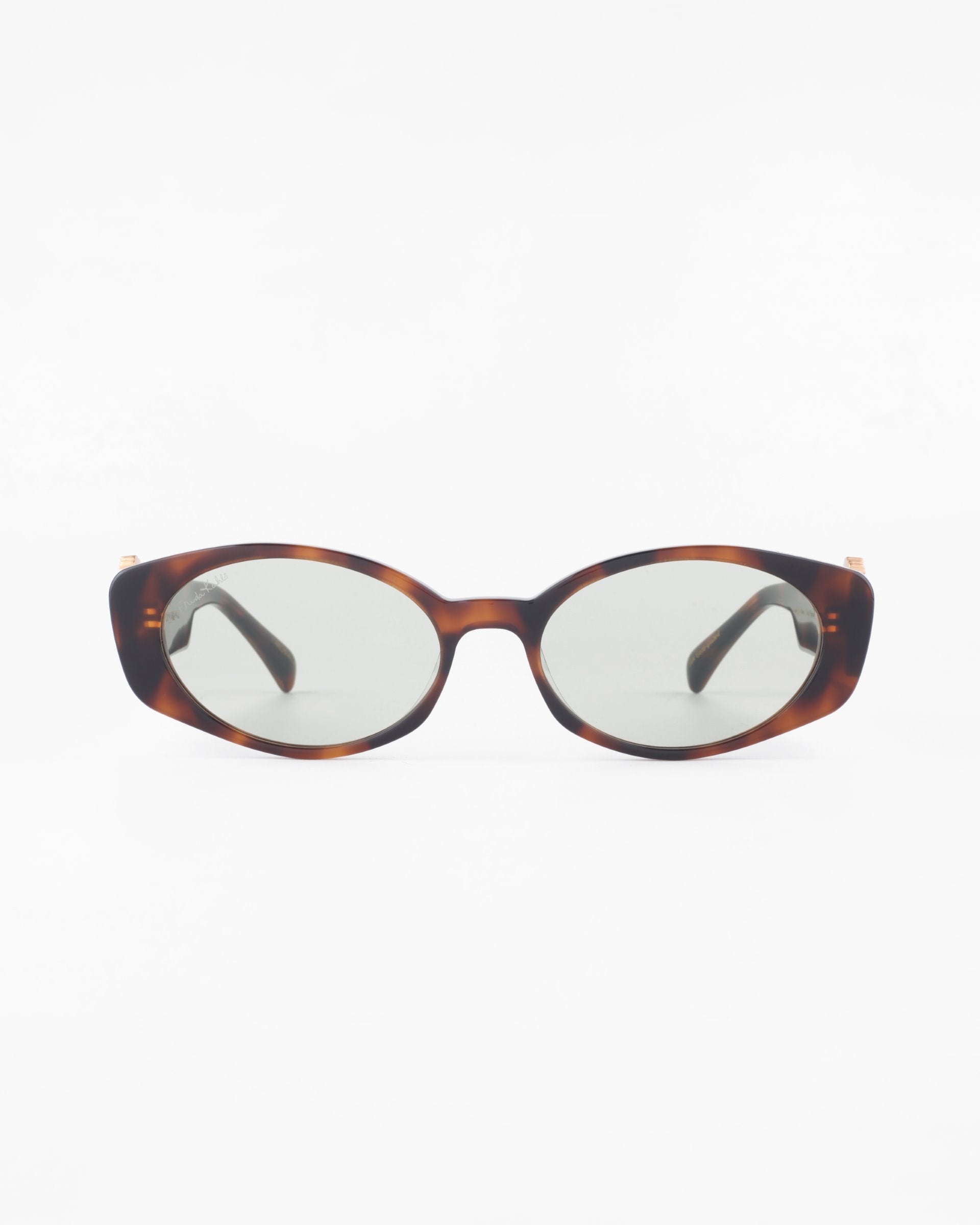 A pair of For Art&#39;s Sake® Frida Portrait sunglasses with brown tortoiseshell frames and ultra-lightweight Nylon lenses, offering 100% UVA &amp; UVB protection. The dark-tinted lenses complement the frames and are positioned facing forward against a plain white background.