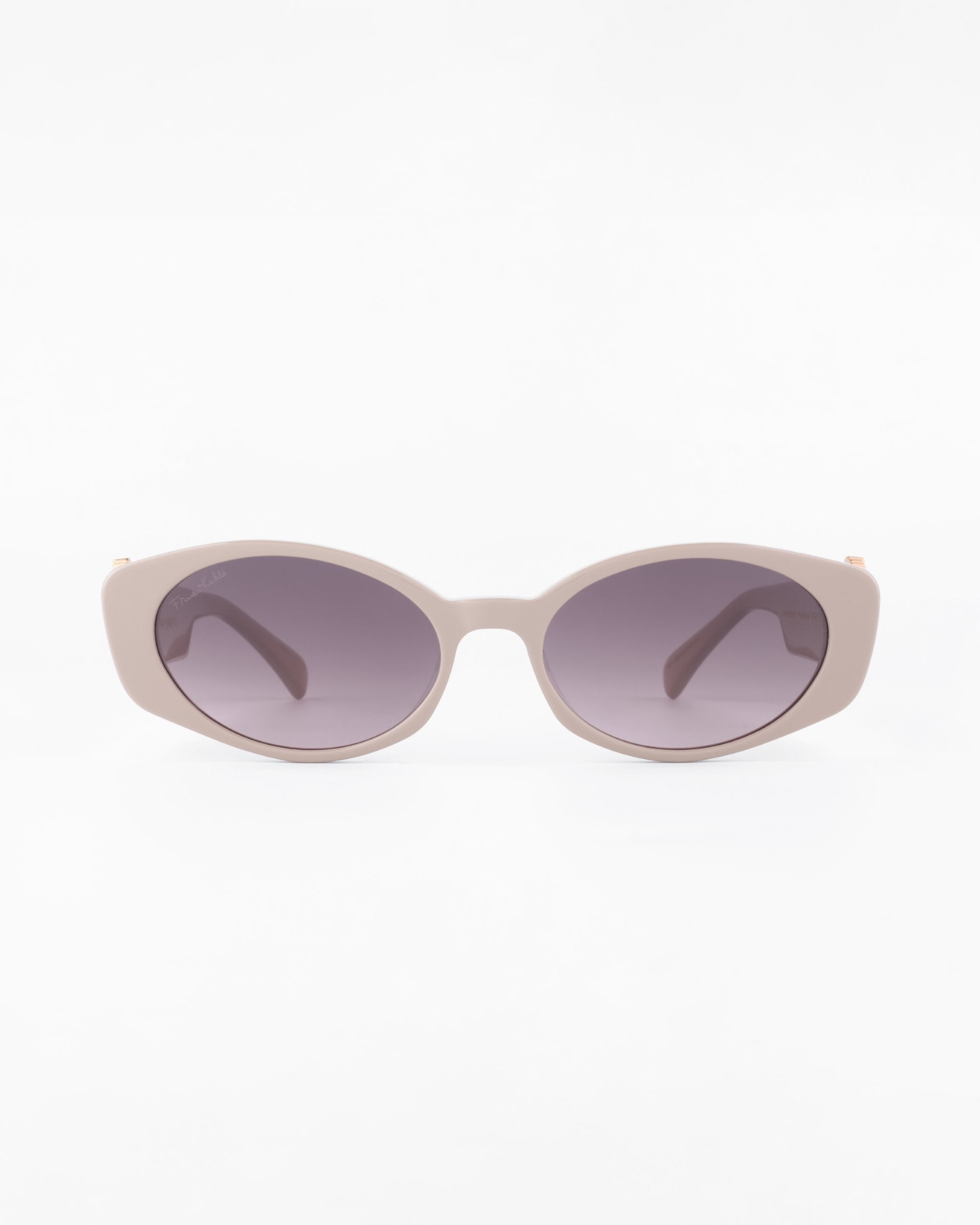 A pair of Frida Portrait sunglasses by For Art&#39;s Sake® with large, round, ultra-lightweight nylon lenses tinted in a gradient from dark to light gray. The sunglasses offer 100% UVA &amp; UVB protection and are positioned facing forward against a plain white background.