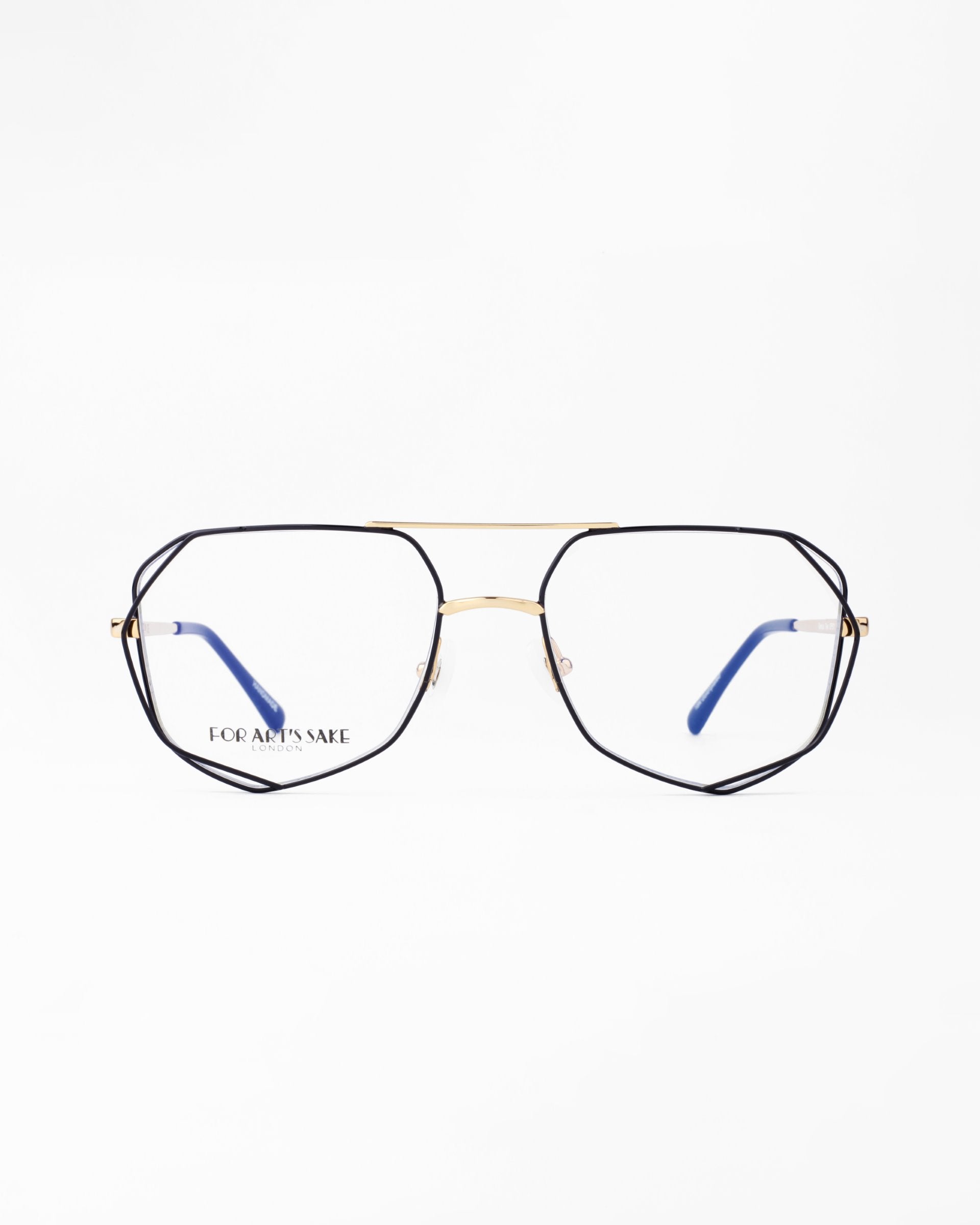 A pair of eyeglasses with hexagonal black frames, gold bridge, and blue-tipped temples is centered against a white background. The brand name "For Art's Sake®" is visible on the left lens. Featuring a Blue Light Filter, the Genius Two glasses are perfect for digital screen use.