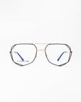 A pair of eyeglasses with hexagonal black frames, gold bridge, and blue-tipped temples is centered against a white background. The brand name "For Art's Sake®" is visible on the left lens. Featuring a Blue Light Filter, the Genius Two glasses are perfect for digital screen use.