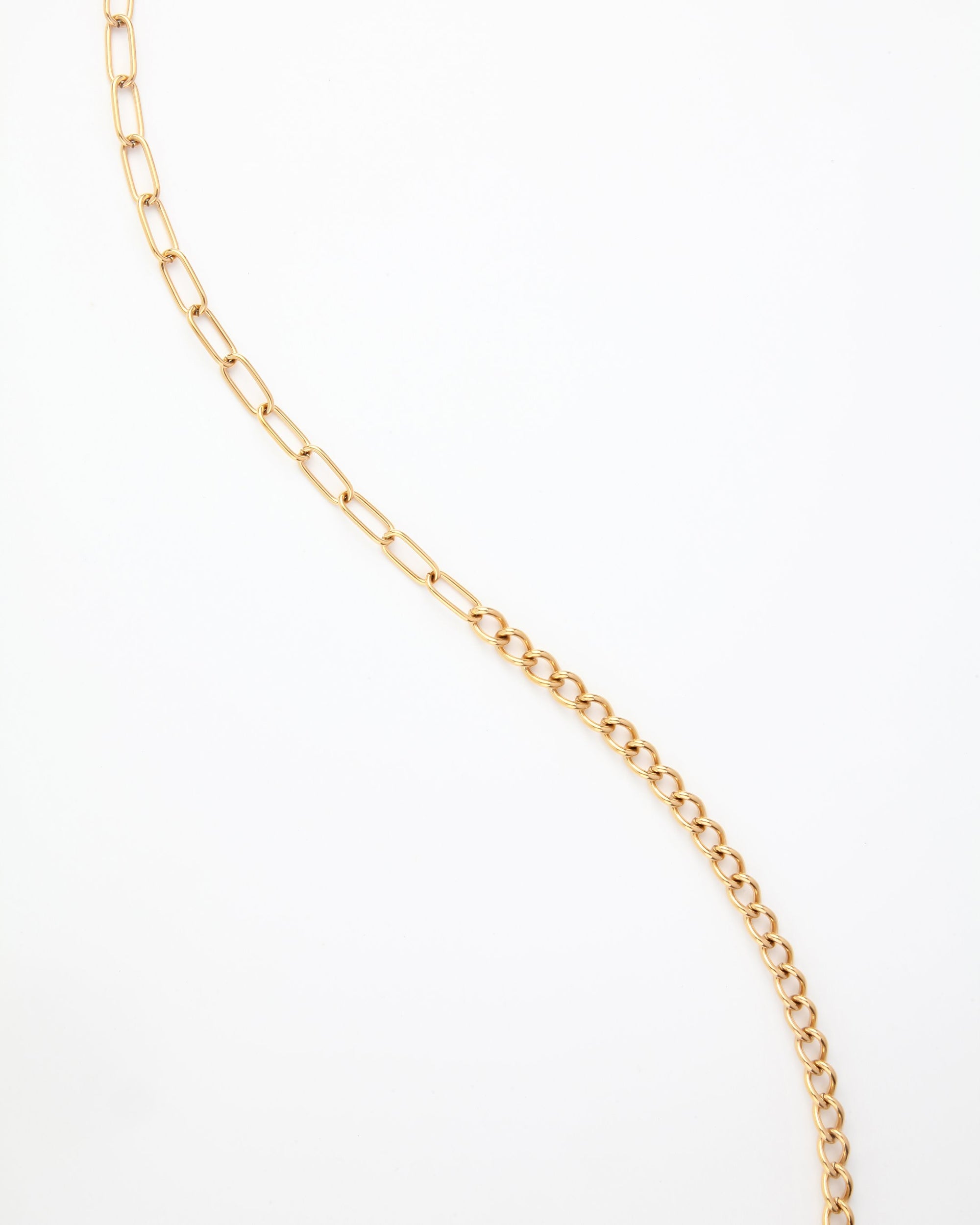 A For Art's Sake® Gabriel Glasses Chain displayed on a white background. The 18K gold-plated links vary in size, with larger oval links transitioning to smaller, more tightly connected circular links. The chain is arranged in a loose, wavy pattern across the background.