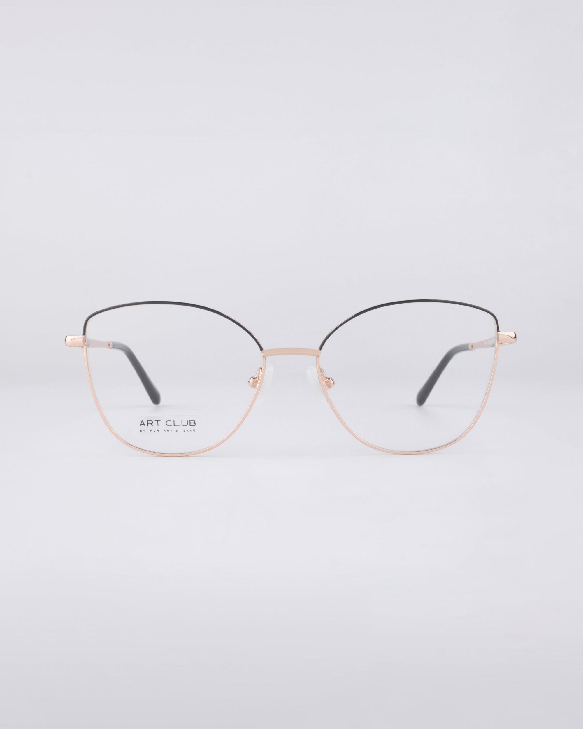 A pair of minimalist Greta eyeglasses from For Art's Sake®, showcasing a sleek blend of gold and black metal in a thin frame. Set against a plain white background, these frames feature blue light filter lenses and offer a subtle cat-eye shape that embodies sustainable luxury.