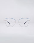 Introducing the Greta eyeglasses by For Art's Sake®: These stylish frames boast thin, metallic silver construction with chic blue accents on the top rim. Designed with a modern, minimalist aesthetic, they offer sustainable luxury and come equipped with blue light filter lenses, all set against a light gray backdrop.