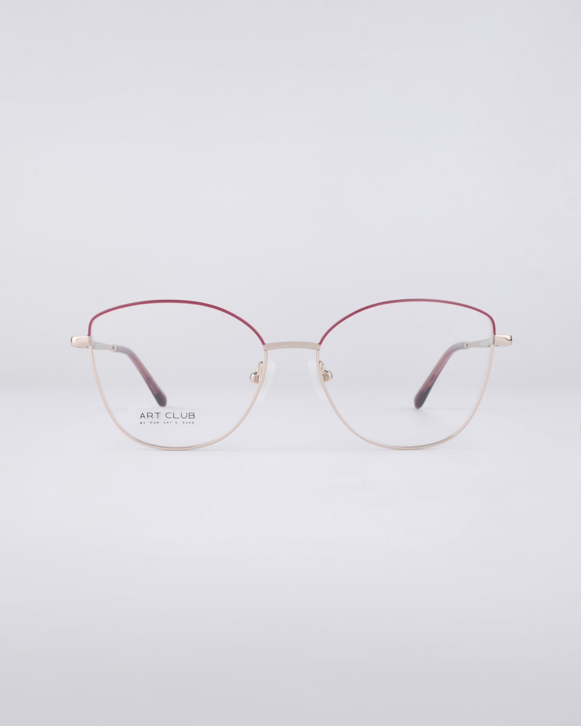 For Art&#39;s Sake® presents the Greta eyeglasses, showcasing thin, round frames. The top half is elegantly red, transitioning to a gold bottom half, and equipped with blue light filter lenses against a plain white background.