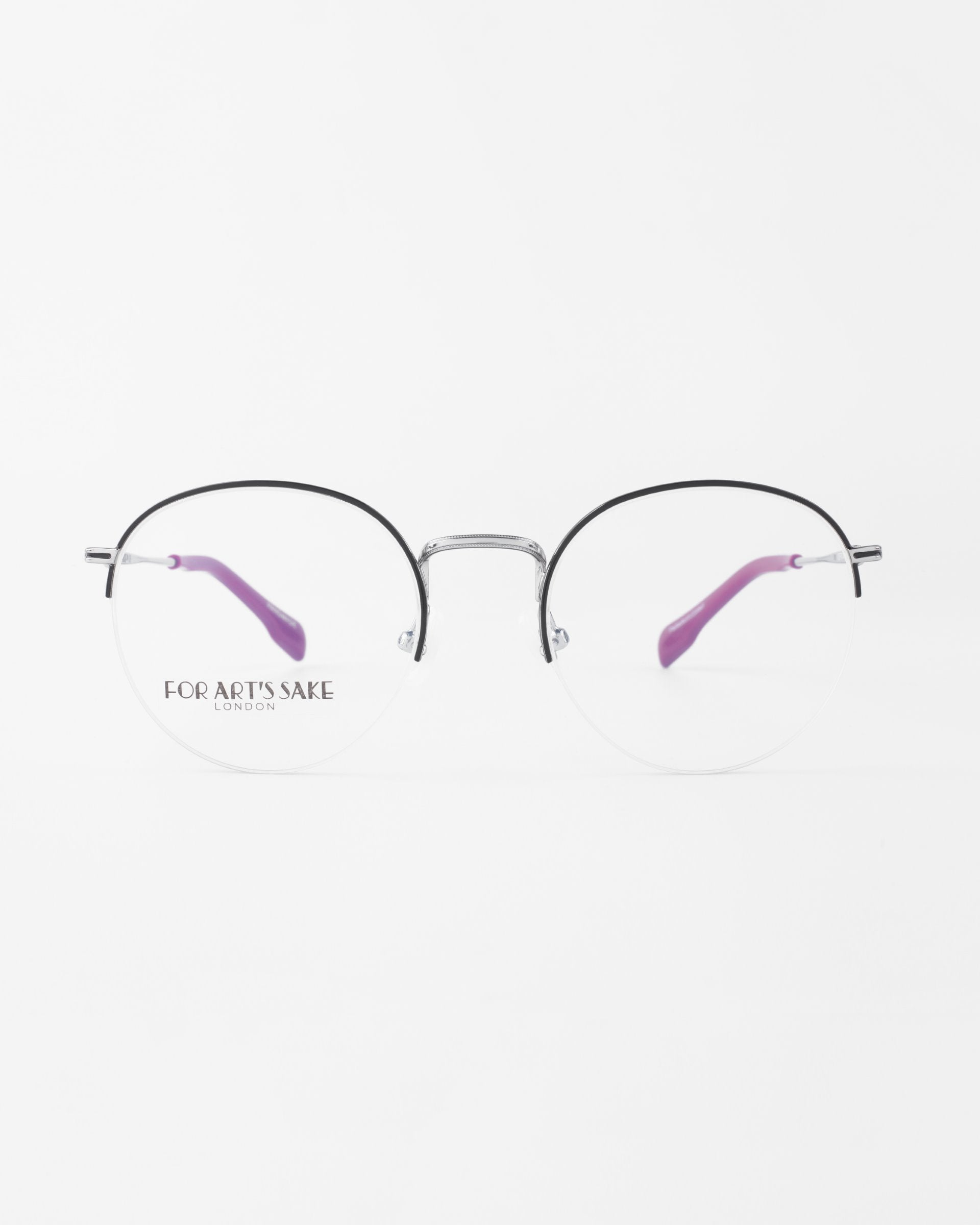 A pair of round, silver-framed glasses with purple, slightly curved earpieces. One lens has the text "For Art's Sake®" printed on it. Offering blue light filter technology, these stylish frames are perfect for the modern, tech-savvy individual. The background is plain white. The product name is Ivy from For Art's Sake®.