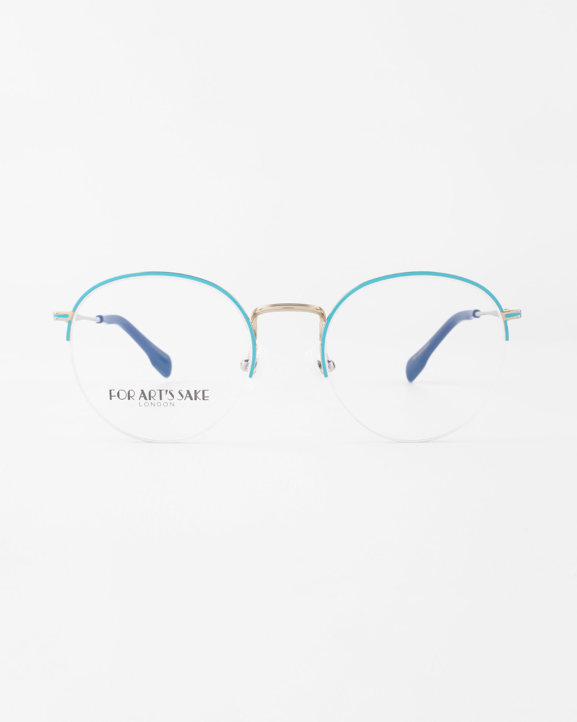 Image of a pair of eyeglasses with a metal frame. The top of the frames is turquoise, and the temples are also turquoise with blue tips. "FOR ART'S SAKE LONDON" is printed on the left lens. These stylish Ivy glasses by For Art's Sake®, designed for both fashion and function, include prescription lenses with a blue light filter. The background is white.