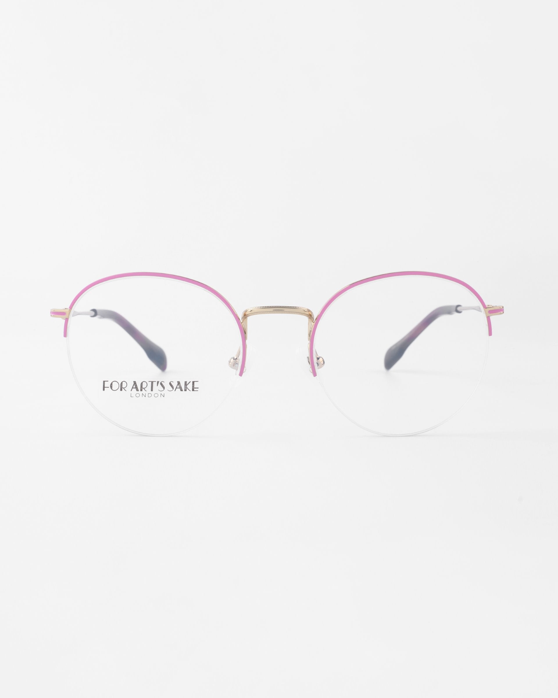 A pair of Ivy reading glasses by For Art&#39;s Sake® with a thin gold bridge and pink rims. The earpieces are black with gold accents near the hinges. Featuring blue light filter lenses, the words &quot;For Art&#39;s Sake® London&quot; are printed on the left lens. The background is plain white.