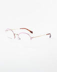 Here is the sentence with the specified product name and brand name:

A pair of For Art's Sake® Ivy minimalist eyeglasses with thin gold frames and subtly tinted pink upper rims. The temples are gold with brown tips. Featuring clear prescription lenses with a blue light filter, the overall design is sleek and modern against a plain white background.