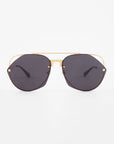 A pair of stylish For Art's Sake® Casino sunglasses with dark, hexagonal nylon lenses and a gold metal frame. The sunglasses also feature a double bridge design and black temple tips, offering top-notch UV protection. The background is plain white.