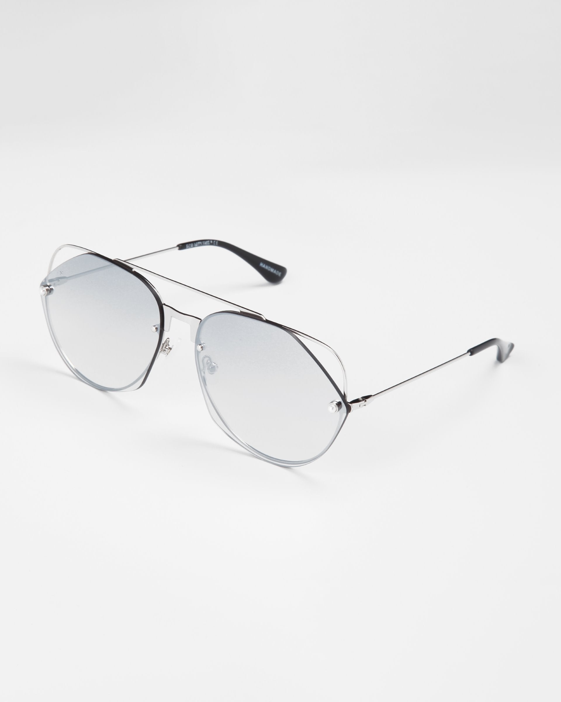 A pair of For Art's Sake® Casino sunglasses with thin metal frames and large, slightly tinted nylon lenses are shown against a plain white background. The sunglasses offer UV protection and have curved black temple tips for added comfort.