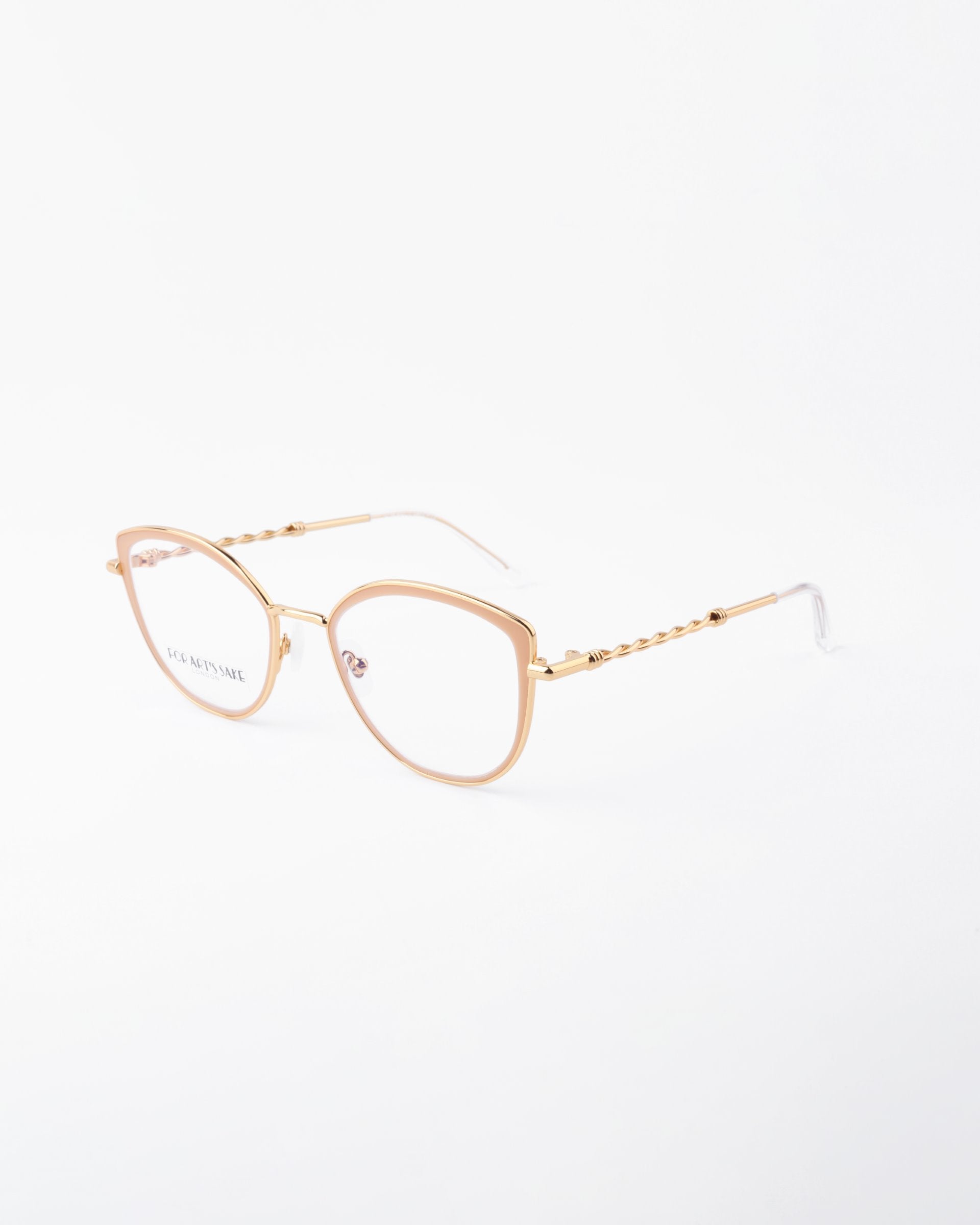 Gold-framed eyeglasses with a subtle cat-eye shape, featuring clear blue light filter lenses and intricate detailing on the arms. The brand name "For Art's Sake®" is visible on the left lens. The frame rests against a plain white background.
