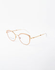 Gold-framed eyeglasses with a subtle cat-eye shape, featuring clear blue light filter lenses and intricate detailing on the arms. The brand name "For Art's Sake®" is visible on the left lens. The frame rests against a plain white background.