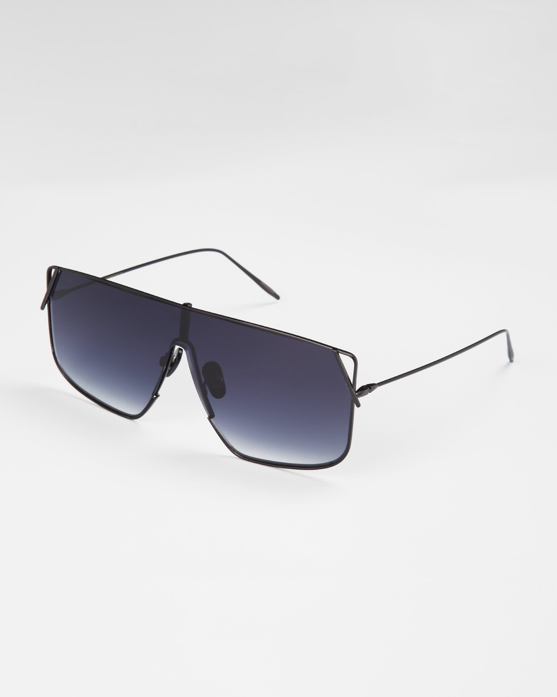 A pair of black, oversized square Horizon sunglasses with dark-tinted lenses, stainless steel frames, and thin metal arms resting on a white surface. These stylish glasses from For Art&#39;s Sake® offer both UVA &amp; UVB protection.
