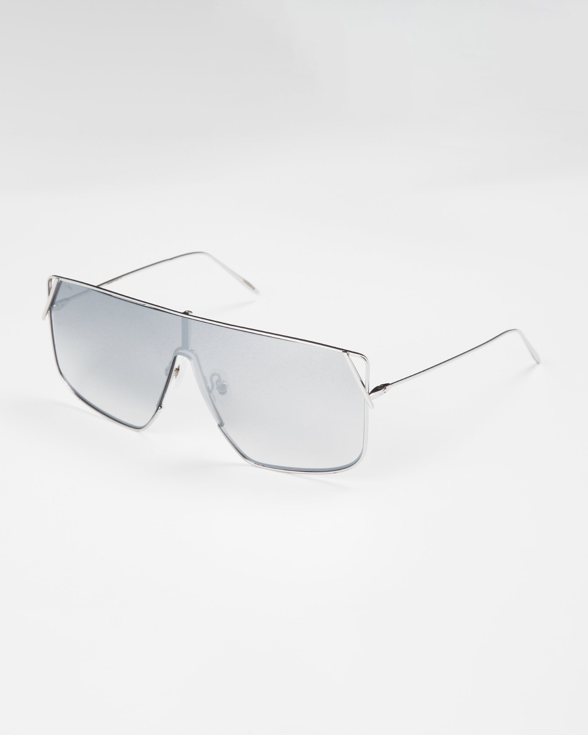 A pair of Horizon sunglasses by For Art&#39;s Sake® with silver-tinted lenses and thin stainless steel frames. The rectangular lenses feature a slight angular cut near the nose bridge, giving them a sleek and stylish appearance. Complete with adjustable nosepads and full UVA &amp; UVB protection. The background is plain white.