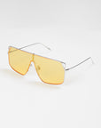A pair of For Art's Sake® Horizon sunglasses with a stainless steel frame and large, rectangular yellow-tinted lenses is displayed against a plain white background. The design features a bridge bar, thin temple arms, and adjustable nosepads for added comfort.
